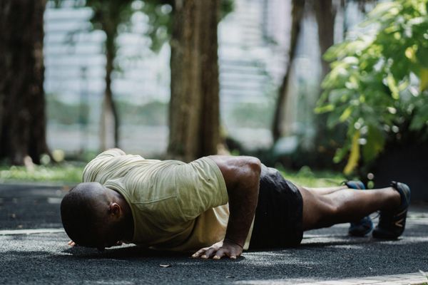 Man in deep concentration during a physical exercise routine.
